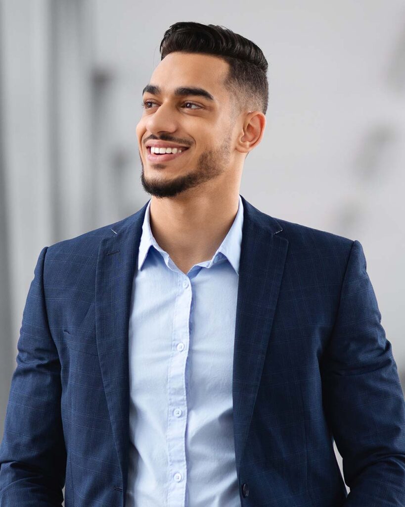 Handsome Young Middle Eastern Man Waiting Flight At Airport Terminal, Looking At Window